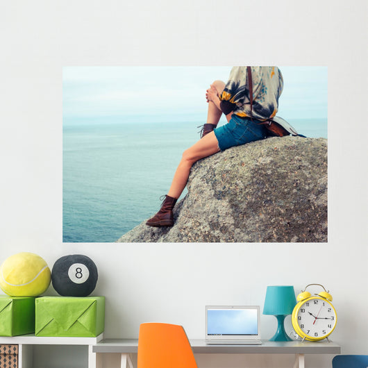 Young Woman Sitting Rock Wall Mural