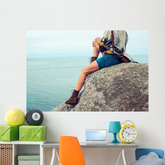 Young Woman Sitting Rock Wall Mural