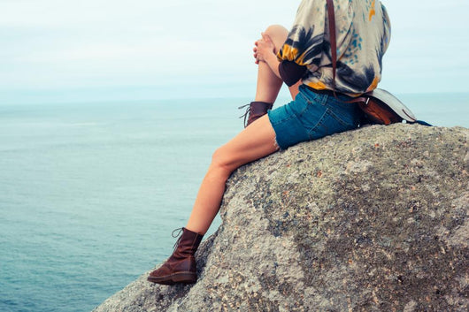 Young Woman Sitting Rock Wall Mural