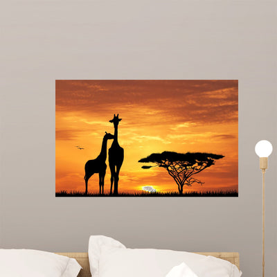 Baby Giraffe Silhouette Sunset Wall Mural shown on a wall