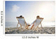 romantic couple on deckchair relaxing on the beach Wall Mural