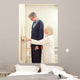 General practitioner measuring male patient's height in hospital Wall Mural