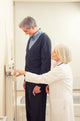 General practitioner measuring male patient's height in hospital Wall Mural