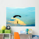unidentified skydiver, parachutist on blue sky Wall Mural
