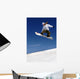 Woman Snowboarder in Flight With Sky Behind Wall Mural