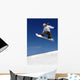 Woman Snowboarder in Flight With Sky Behind Wall Mural