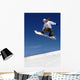 Woman Snowboarder in Flight With Sky Behind Wall Mural