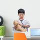 Young Asian doctor boy playing and curing bear toy isolated on w Wall Decal