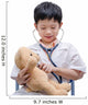 Young Asian doctor boy playing and curing bear toy isolated on w Wall Decal