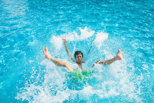 Man falling and splashing into water Wall Mural