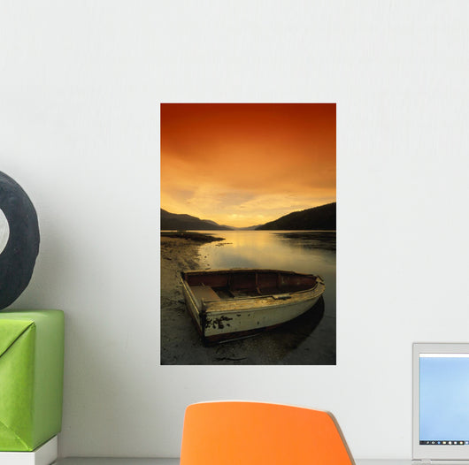 Old Rowboat At Water's Edge With Sunset Background Wall Mural