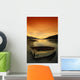 Old Rowboat At Water's Edge With Sunset Background Wall Mural