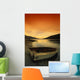 Old Rowboat At Water's Edge With Sunset Background Wall Mural