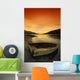 Old Rowboat At Water's Edge With Sunset Background Wall Mural
