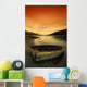 Old Rowboat At Water's Edge With Sunset Background Wall Mural