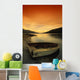 Old Rowboat At Water's Edge With Sunset Background Wall Mural