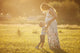 Small boy kissing belly of his pregnant mother outdoors Wall Mural