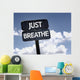 Just Breathe sign with clouds and sky background Wall Mural