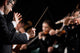 Conductor directing symphony orchestra Wall Mural