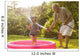 Grandparent and grandkid playing with hose Wall Mural