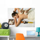 portrait of young beautiful woman in spa environment, massage wi Wall Mural