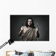 Hungry wild man wearing leopard skin hold fork and knife. Wall Mural