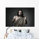 Hungry wild man wearing leopard skin hold fork and knife. Wall Mural