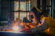 Worker welding the steel part by manual Wall Mural