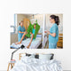 Nurses Looking At Patient Sitting On Cloth Of Hydraulic Lift Wall Mural