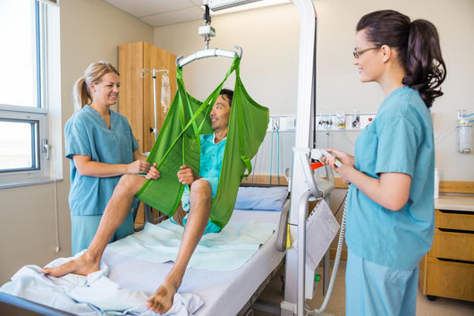 Nurses Looking At Patient Sitting On Cloth Of Hydraulic Lift Wall Decal