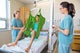 Nurses Looking At Patient Sitting On Cloth Of Hydraulic Lift Wall Decal