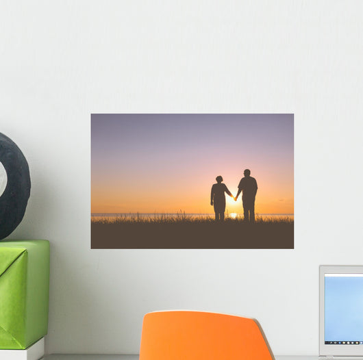 Senior couple holding hands silhouettes Wall Mural
