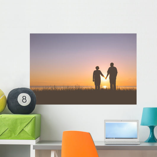 Senior couple holding hands silhouettes Wall Mural