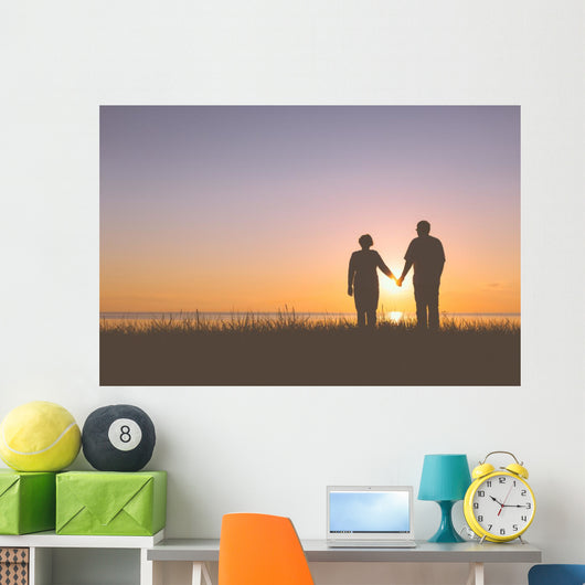 Senior couple holding hands silhouettes Wall Mural