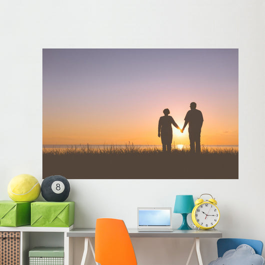 Senior couple holding hands silhouettes Wall Mural