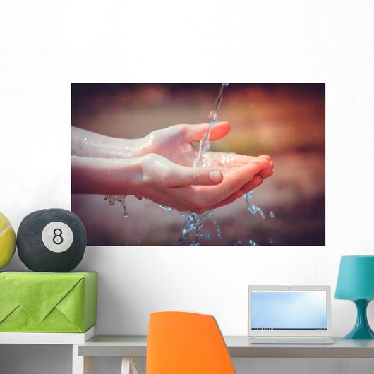 Woman's hands with water splash Wall Mural