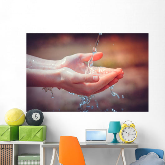 Woman's hands with water splash Wall Mural