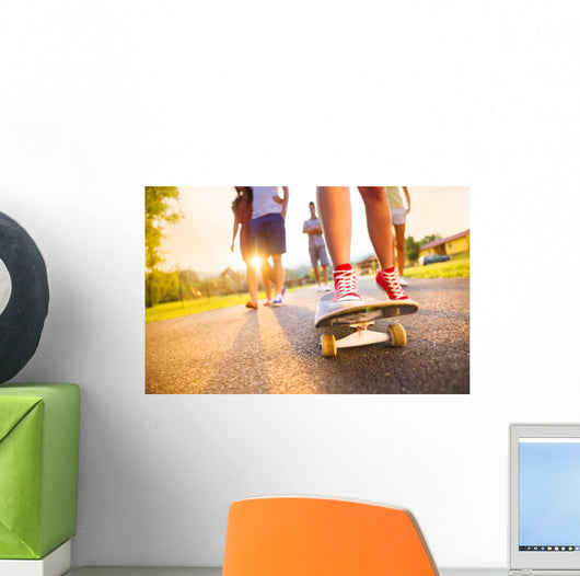 Young peoples legs with skateboard Wall Mural