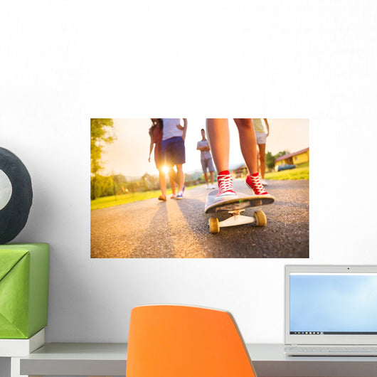 Young peoples legs with skateboard Wall Mural