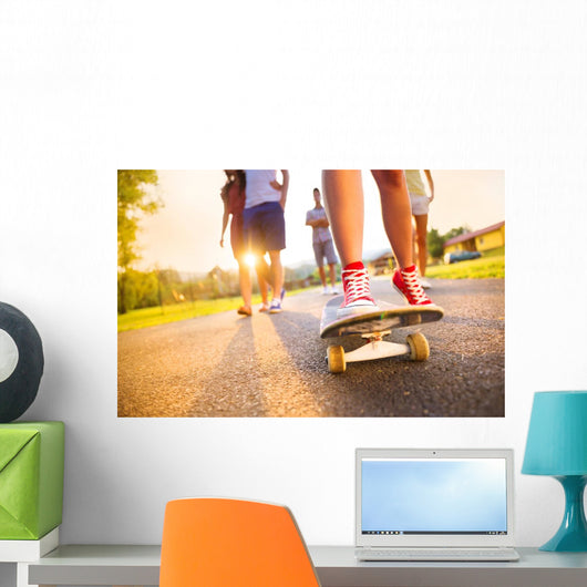 Young peoples legs with skateboard Wall Mural