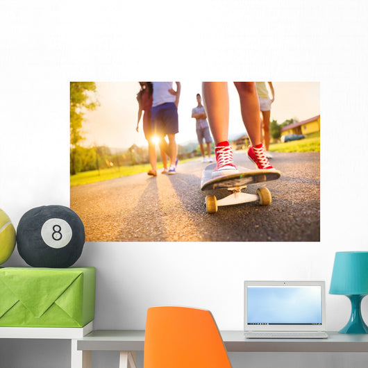 Young peoples legs with skateboard Wall Mural