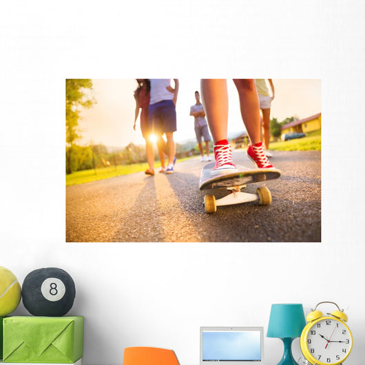Young peoples legs with skateboard Wall Mural