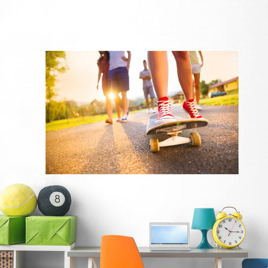 Young peoples legs with skateboard Wall Mural