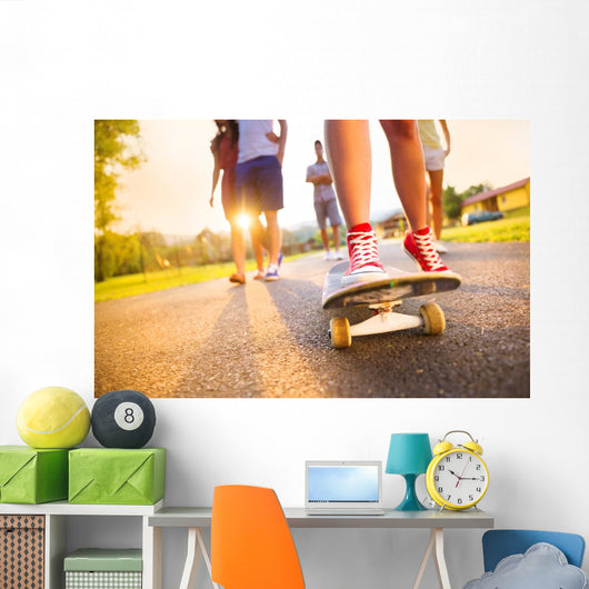 Young peoples legs with skateboard Wall Mural