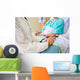 Female Doctor Sitting With Patient On Hospital Bed Wall Mural