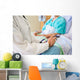 Female Doctor Sitting With Patient On Hospital Bed Wall Mural