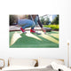 Young woman plays adventure/mini golf in summer evening Wall Mural