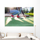 Young woman plays adventure/mini golf in summer evening Wall Mural