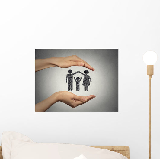 woman's hands protecting happy family, grey wall background  Wall Mural