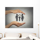 woman's hands protecting happy family, grey wall background  Wall Mural